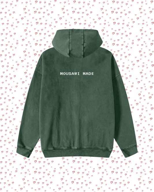 Green hoodie with 'MOUSAWI MADE' text on a white background with red heart patterns