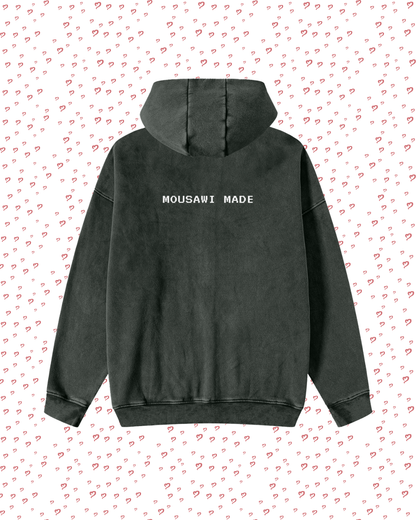 Black hoodie with 'MOUSAWI MADE' text on a white background with red heart patterns