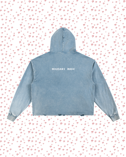 Blue hoodie with 'Mousavi Made' text on a white background with red heart patterns
