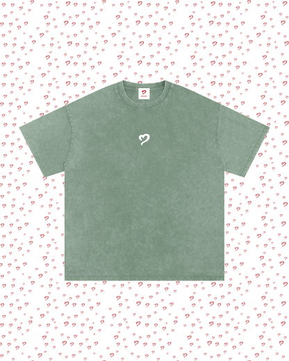 Green t-shirt with a heart design on a white background with red heart patterns