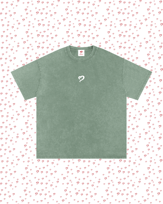 Green t-shirt with a heart design on a white background with red heart patterns