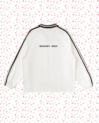 White sweatshirt with black trim on a pink background with heart patterns